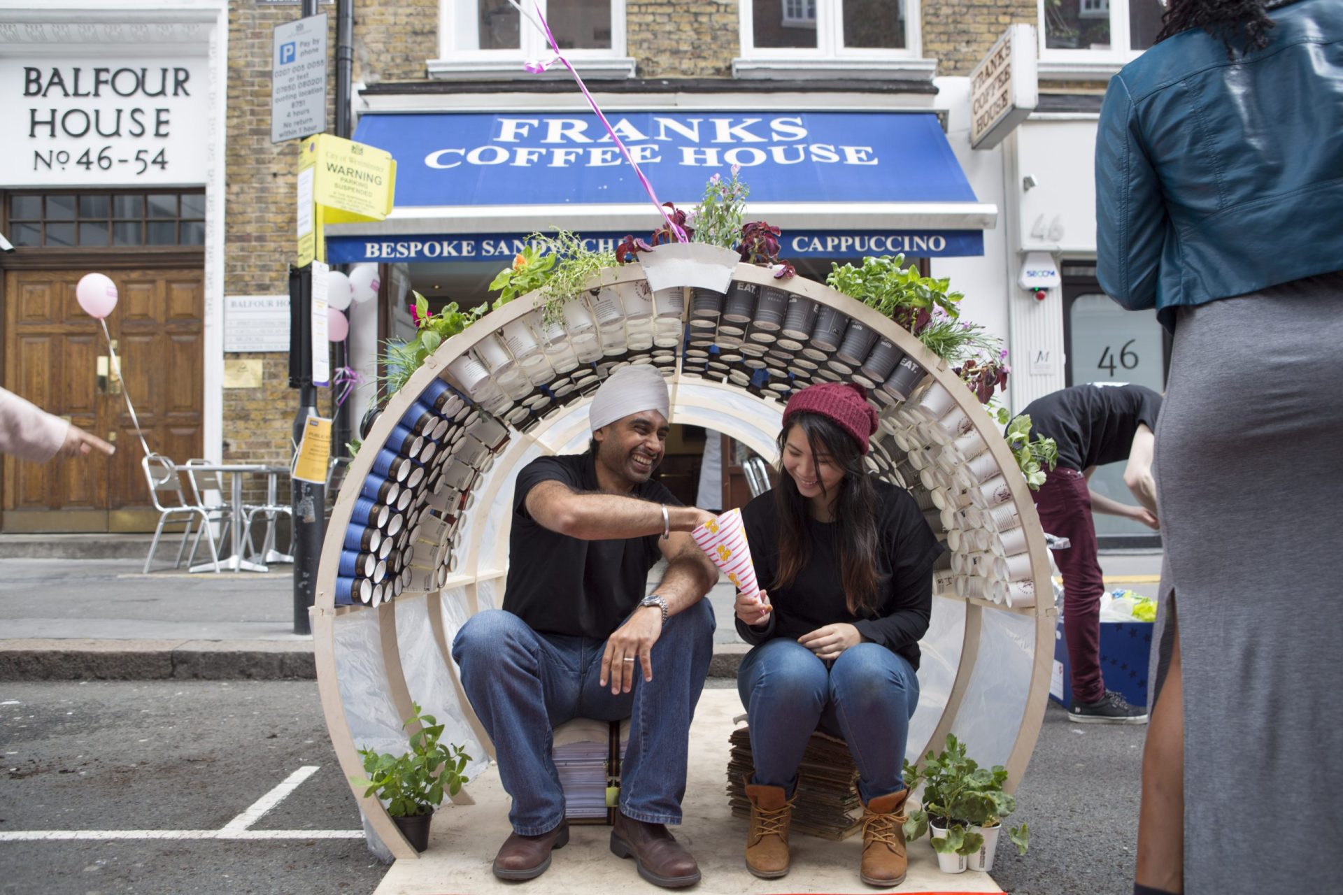 Two people sitting on a bench in Fitzrovia