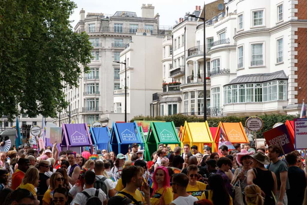 Image of the float during the parade, five colourful structures lined up in a rainbow.